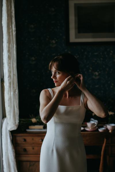 Bride puts on her earrings