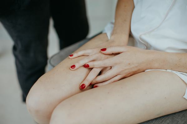 Hands cupped red nail varnish bride