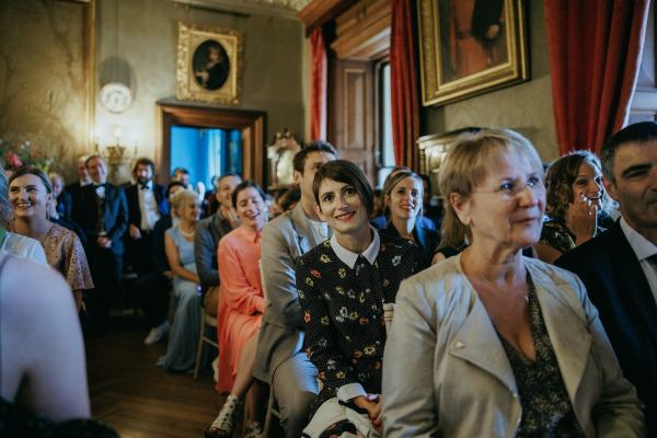 Guests smile during ceremony setting seated