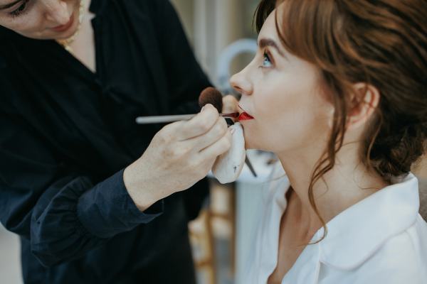 Bride gets her makeup done MUA red lipstick