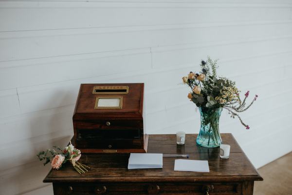 Table setting and opinion box flowers in vase