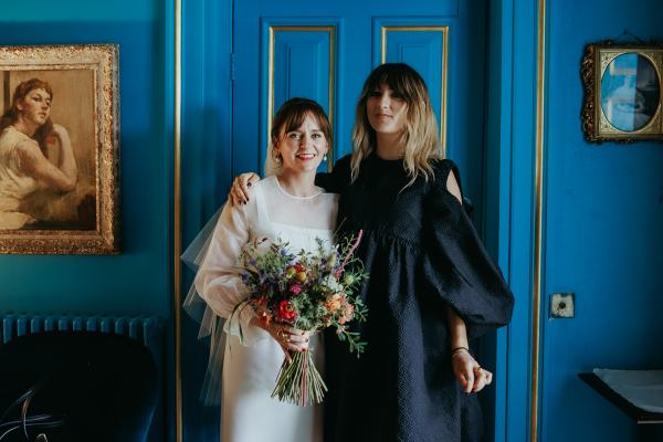 Bride and bridesmaids wearing black dress poses