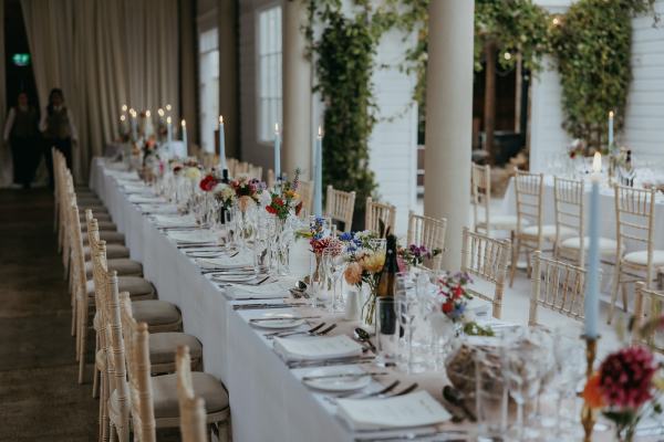 Empty dining room setting table and chairs cutlery candles lit