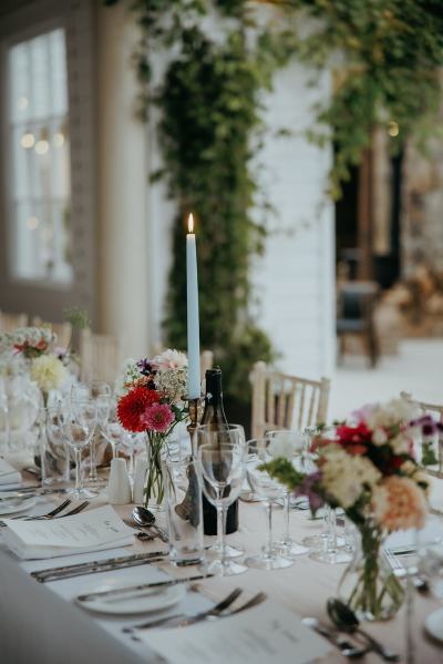 Empty dining room setting table and chairs cutlery candles lit