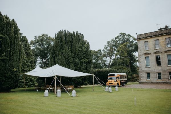 Marquee tent grass and mini bus parked