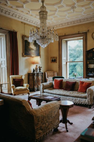 Interior stately home couch sofa chairs setting and chandelier