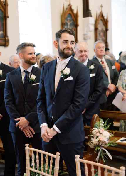 Groom smiles towards his bride