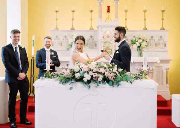 Bride and groom at the alter with witnesses groomsmen