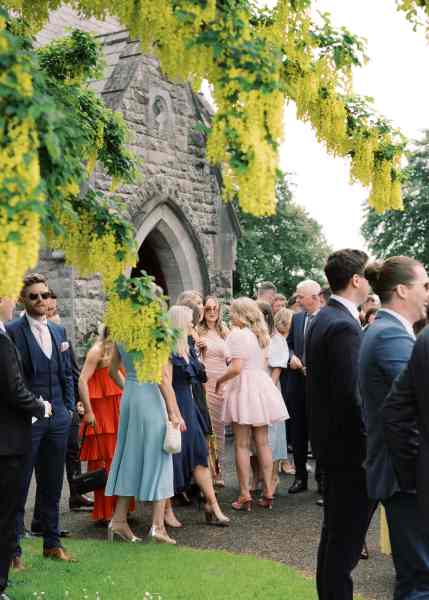 Guests gather outside of church