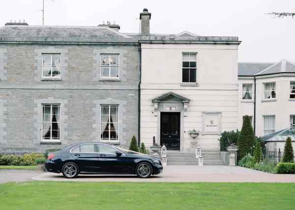 Exterior wedding venue and black car