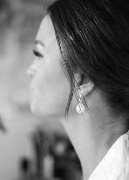 Black and white bride earring detail as she gets ready