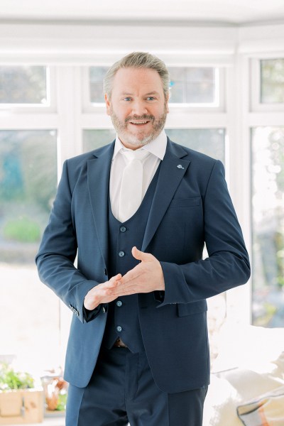 Groom is ready wearing suit smiling