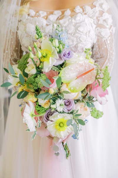 Close up of brides bouquet pink material colourful roses flowers