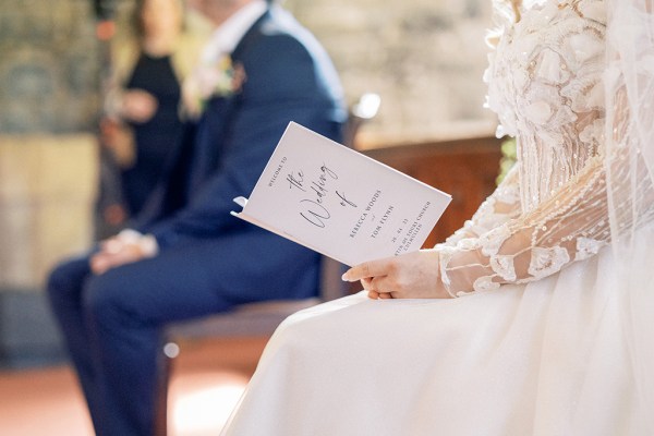 Bride holds booklet pamphlet