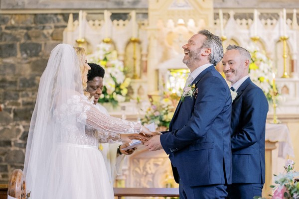 Bride and groom laugh as they exchange vows/rings