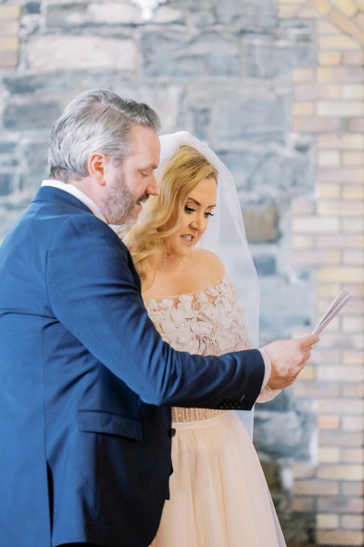 Bride and groom read from the pamphlet during ceremony