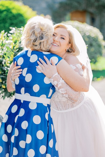 Blue polka dot dress and bride hug/embrace