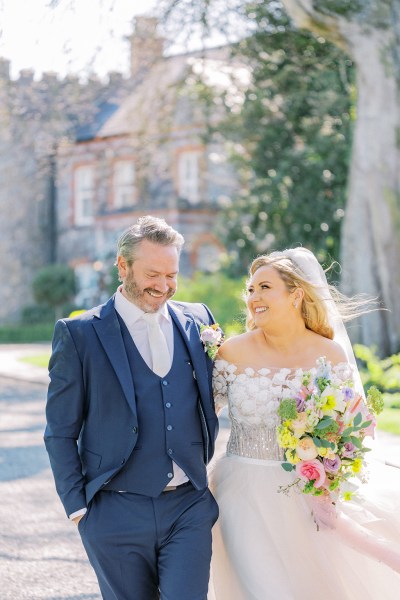 Bride and groom smile laugh together