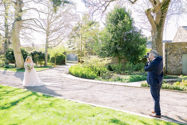 Groom sees bride from afar walking towards him