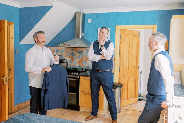 Groom and groomsmen standing in room together