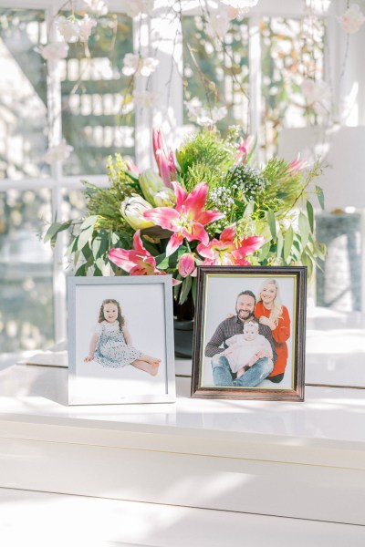 Family photo frames portraits in front of flowers