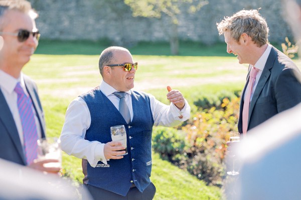 Man in suit chatting to two other men