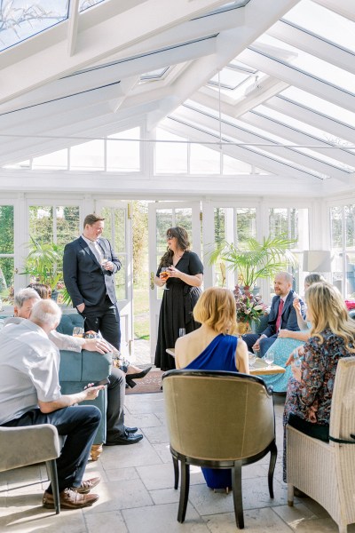 Conservatory atmosphere shot of friends and family chatting