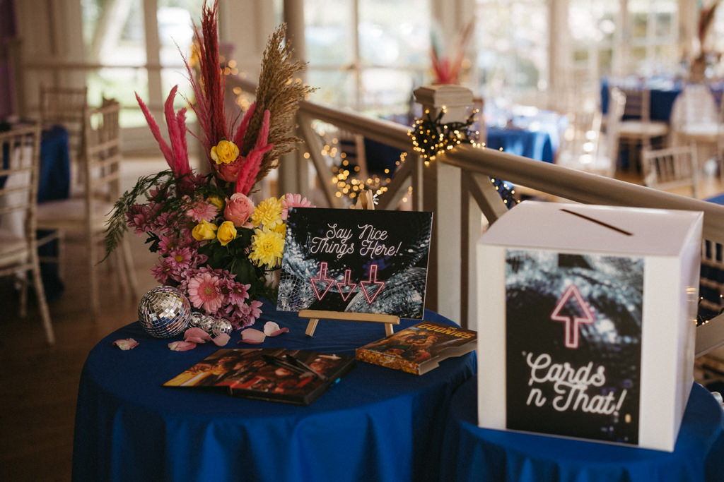 Blue tablecloth arrow writing colourful flowers