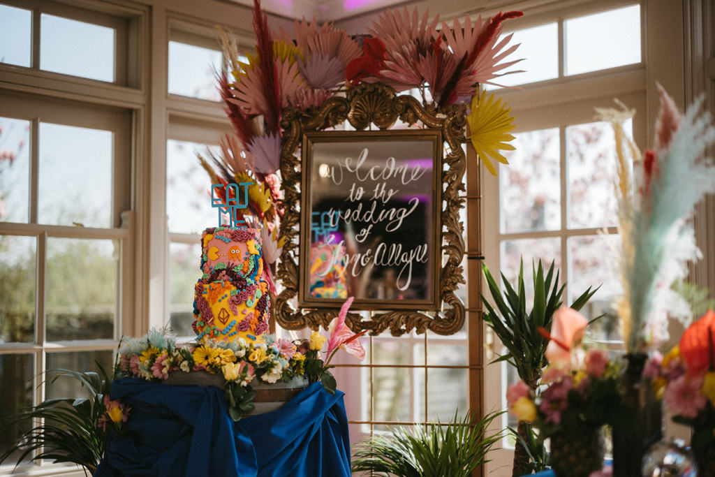 Orange colourful wedding cake on blue tablecloth table