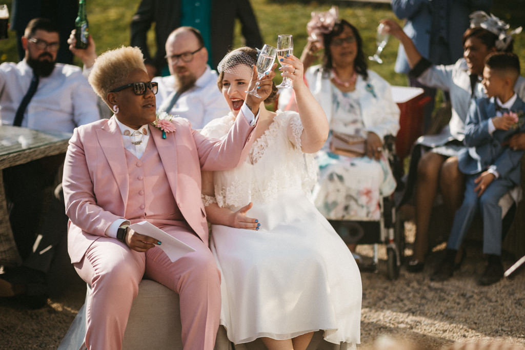 Two brides cheers with glass of champagne