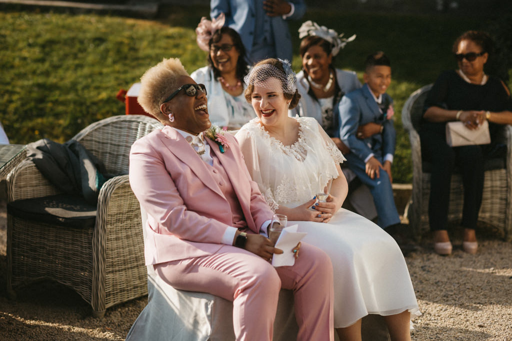 Two brides seated and laughing