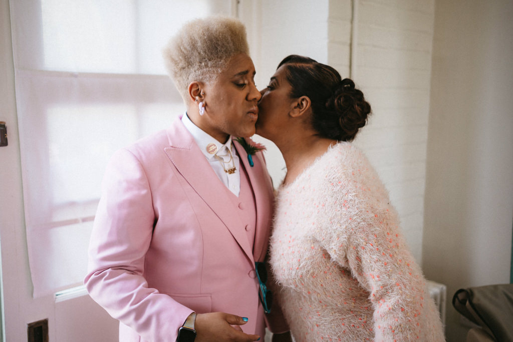 Mother kisses daughter bride on the cheek