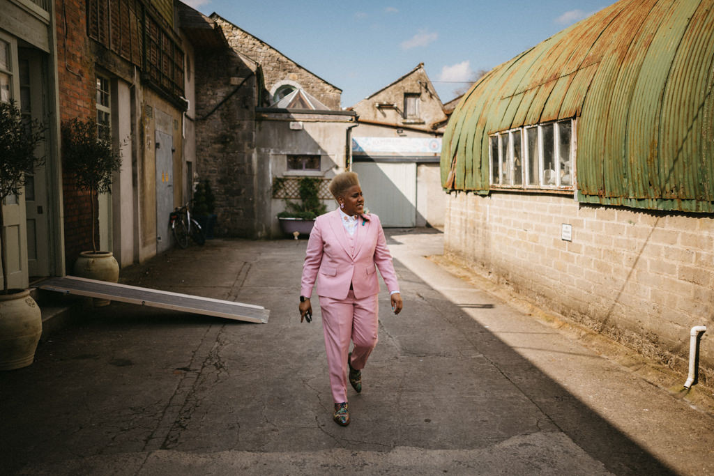 Bride walks through the courtyard makes her way to ceremony