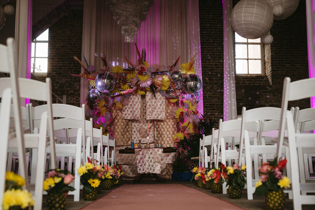 Wide shot of seating area for guests ceremony and alter in view