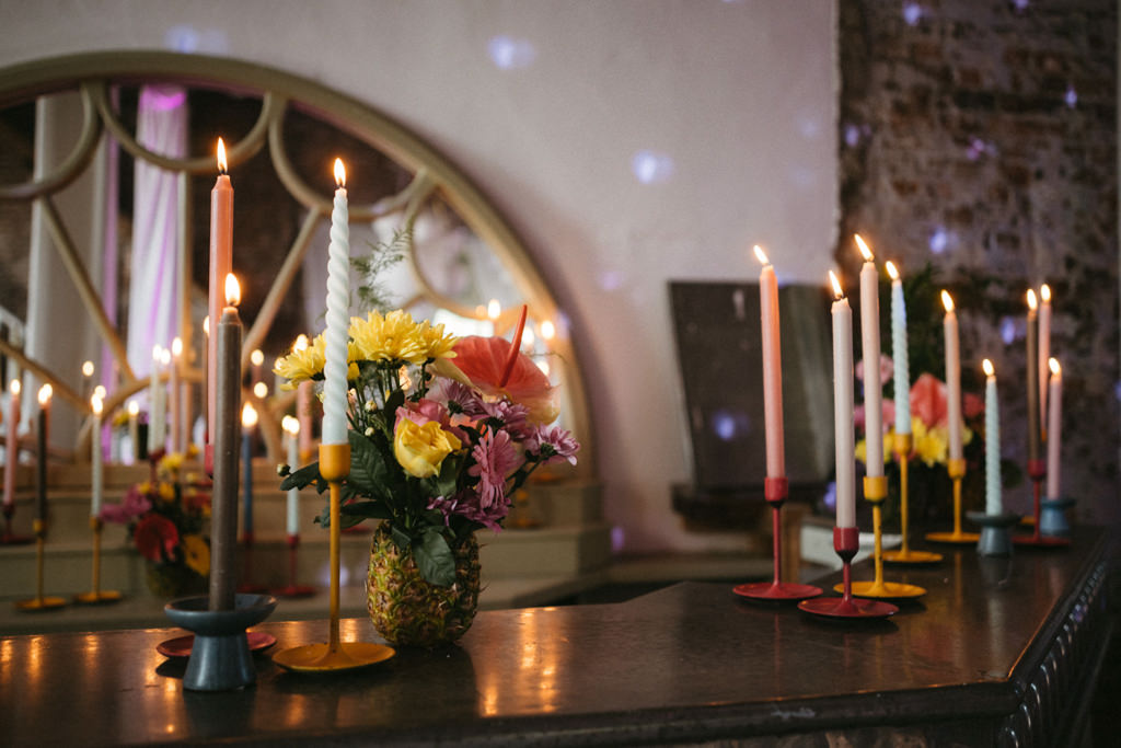 Candles lit on table and flowers/floral setting