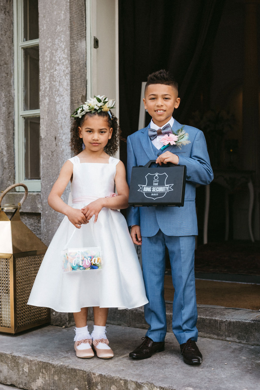 Son and daughter holding up little bags smile