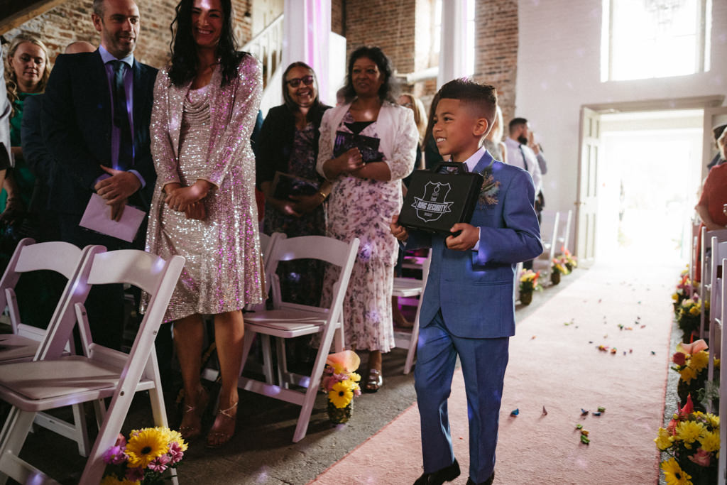 Little boy son walking down the aisle with speaker