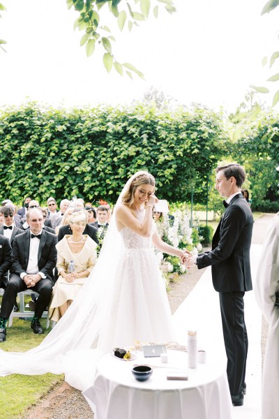 Emotional bride starts to cry at alter with groom they hold hands