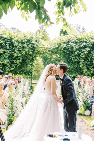 Bride and groom kissing at alter