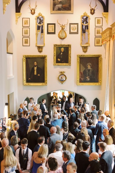 Group family portrait friends guests room full of portraits