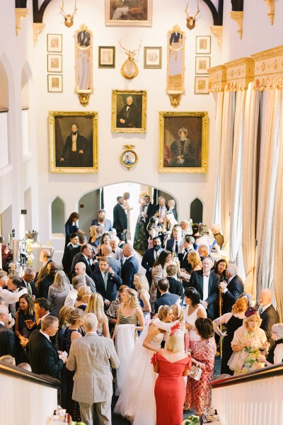 Group family portrait friends guests room full of portraits