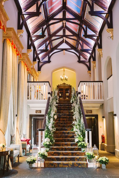 Staircase interior wedding venue covered in flowers