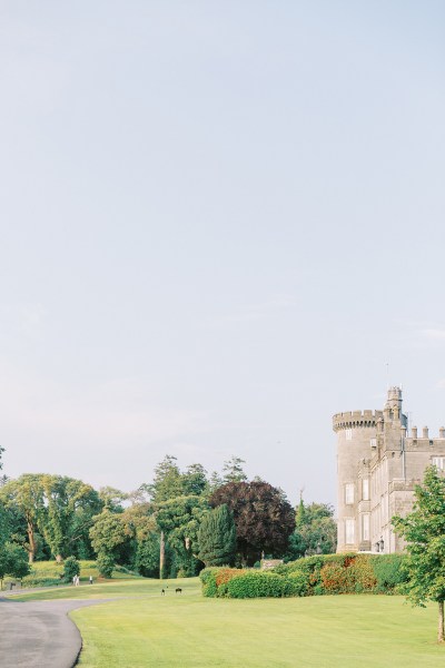 wide shot/drone shot of green grass and wedding venue