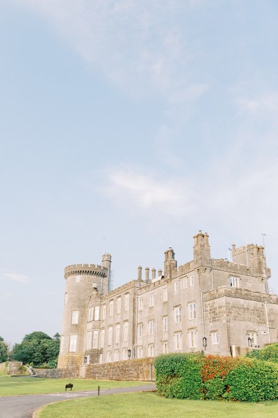 wide shot/drone shot of green grass and wedding venue