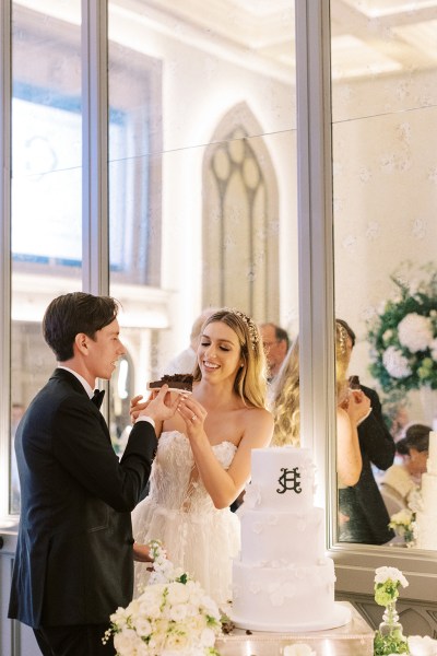 Bride and groom enjoy the wedding cake together