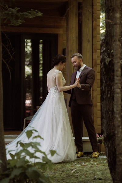 Groom sees his bride for the first time they hold hands