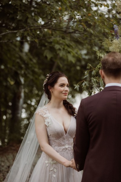 Bride looks at groom during wedding ceremony