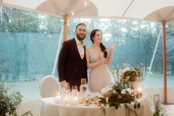 Bride and groom standing at dining room table