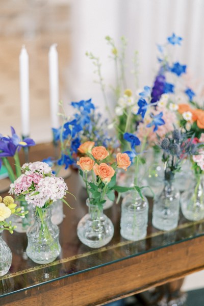 Flowers in vases on top of mantelpiece fireplace