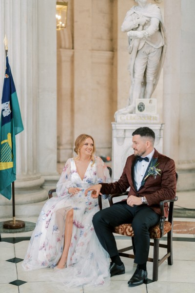 Bride and groom sitting during ceremony interior church